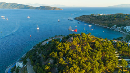 Bodrum, Turkey. Aerial drone view of a lush green hill with Tiger Tower and Turkish flag in Bodrum....