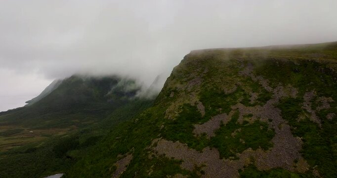 Dramatic mountain fog enveloping mountaintops on Northern Norway, aerial