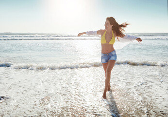 Fototapeta premium Holiday, freedom or woman by ocean water with wind, walk or think on island for adventure with space. Beach, vacation and happy person with arms outstretched, breeze or reflection with view in summer