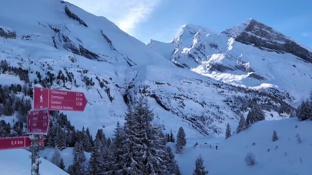 Winter walking and snowshoeing paths trail sign in the Swiss alps