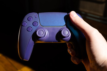 A gamepad for consoles on a white background, gaming addiction, gaming ban for teenagers, gaming controls for parents, for banners and advertising. High quality © Karen Vardanian