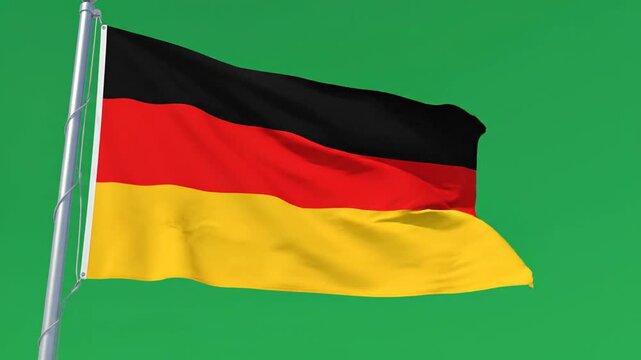 The German flag waves on a pole against a green screen