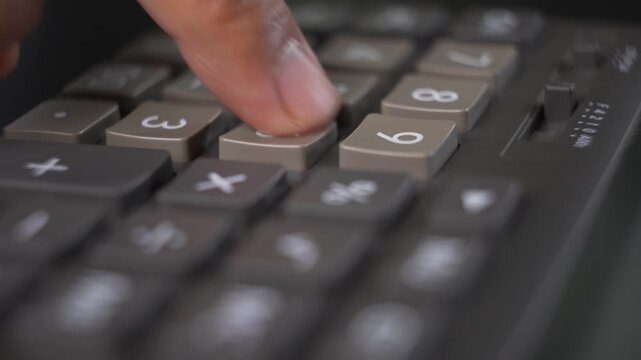 Vintage calculator multiplication operation during a financial calculation close-up