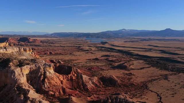 A sweeping drone flight reveals the iconic silhouette of Cerro Pedernal in the distance. This 4K vista captures the monumental scale of the New Mexico high desert landscape.
