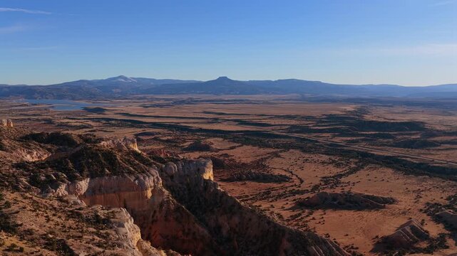 Explore the intricate erosion and colorful sediment of an untouched high desert wilderness. The iconic profile of Cerro Pedernal provides a majestic backdrop for cinematic adventure storytelling.