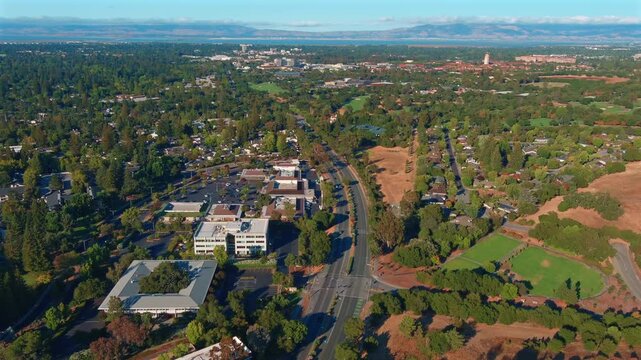 Aerial tilt up from venture capital offices on Sand Hill Road to a clear sunny South Bay skyline in Silicon Valley during daytime