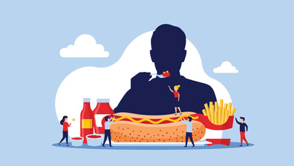Obraz premium Team of small people preparing a giant hot dog with mustard and fries while a large silhouette of a person eats in the background of the image.