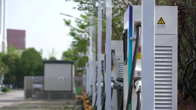 Electric Vehicle Charging Station Row with Yellow Safety Bollards