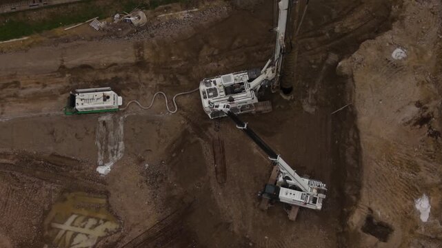 Aerial view of construction equipment working on a new railway project between Milan and Pavia, showing infrastructure development in northern Italy.