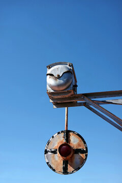 Part of old railway signal under blue sky