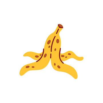 Yellow banana peel discarded on the floor used as a classic slapstick comedy prop for april fools day pranks and safety warning signs. Slippery fruit skin for funny practical jokes
