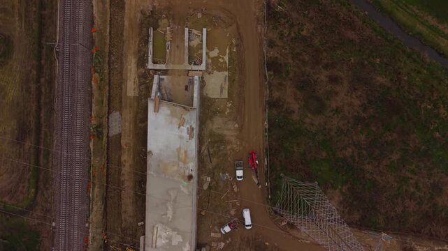 railway tunnel excavation showing industrial machinery, construction vehicles, and new high speed rail infrastructure development in Italy.