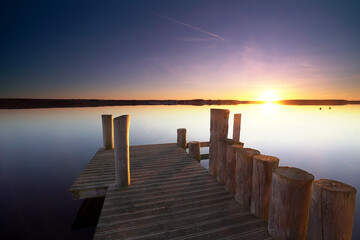 beautiful sunset on the beach near the wooden pier
