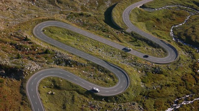 Aerial shot of a serpentine mountain road at Julier Pass crossing the Albula Alps in Switzerland.