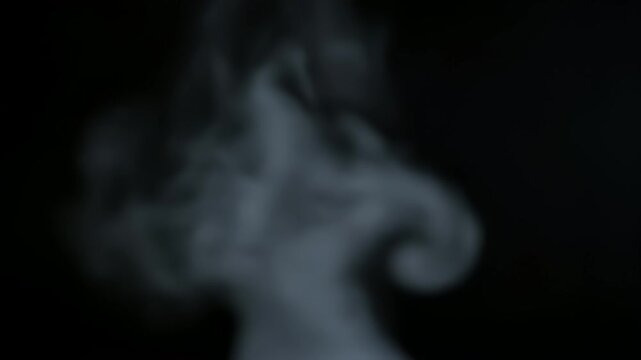 White Smoke Rising on Black Background.