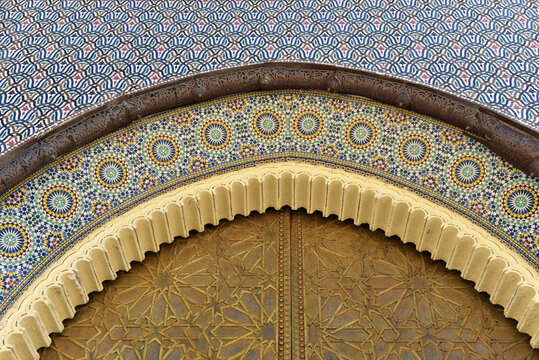 Brass door with Arabic calligraphy and Moroccan zellij mosaic tilework. Royal Palace, Fez, Morocco