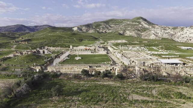 Cinematic aerial drone video of Tripolis Antik Kenti near Buldan in Denizli, Turkey, featuring Roman ruins, columns, stone structures, and panoramic scenic landscape from above.
