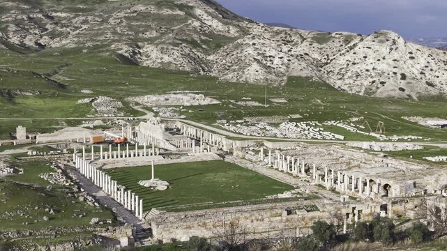 Cinematic aerial drone video of Tripolis Antik Kenti near Buldan in Denizli, Turkey, featuring Roman ruins, columns, stone structures, and panoramic scenic landscape from above.