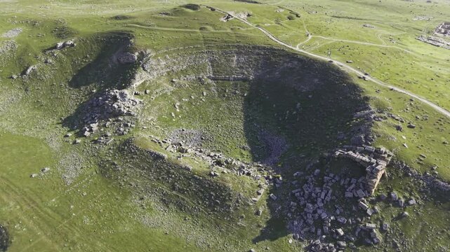 Cinematic aerial drone video of Tripolis Antik Kenti near Buldan in Denizli, Turkey, featuring Roman ruins, columns, stone structures, and panoramic scenic landscape from above.