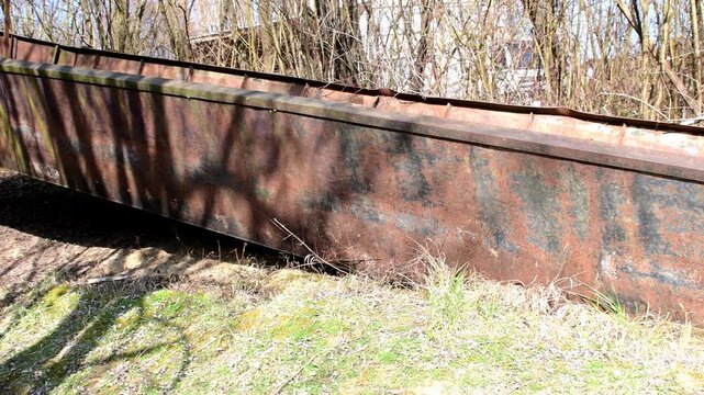 old iron cargo barge at a shore of a river arm in Germany