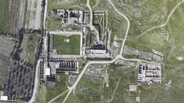Cinematic aerial drone video of Tripolis Antik Kenti near Buldan in Denizli, Turkey, featuring Roman ruins, columns, stone structures, and panoramic scenic landscape from above.