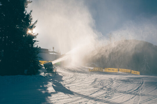 Snow gun blows snow to prepare mountain for skiers and snowboarders