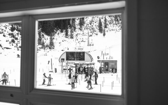 People wait to load chairlift on winter day at Whistler Blackcomb.
