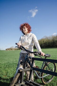 Teenage girl riding a bicycle in the park, spring time