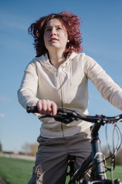 Teenage girl riding a bicycle in the park, spring time