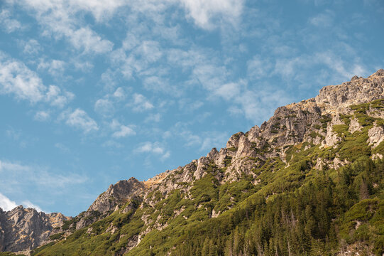 Zakopane's majestic Tatra mountains rise under a bright blue sky