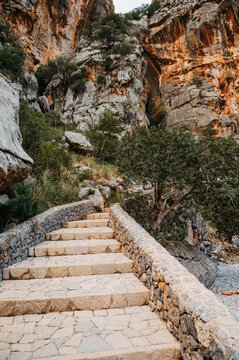 Stone staircase leading into limestone gorge at Torrent de Pareis