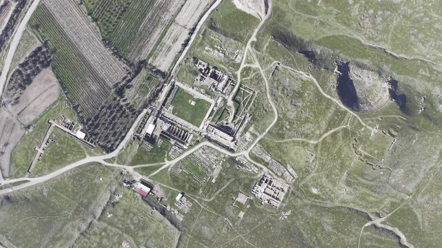 Cinematic aerial drone video of Tripolis Antik Kenti near Buldan in Denizli, Turkey, featuring Roman ruins, columns, stone structures, and panoramic scenic landscape from above.