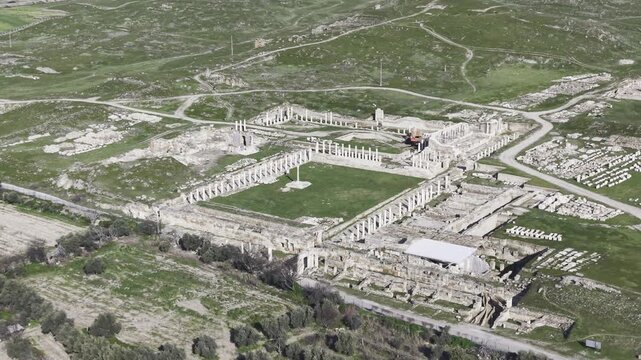 Cinematic aerial drone video of Tripolis Antik Kenti near Buldan in Denizli, Turkey, featuring Roman ruins, columns, stone structures, and panoramic scenic landscape from above.