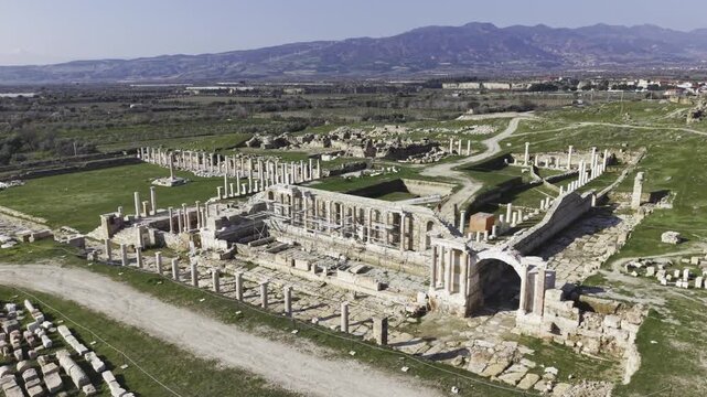 Cinematic aerial drone video of Tripolis Antik Kenti near Buldan in Denizli, Turkey, featuring Roman ruins, columns, stone structures, and panoramic scenic landscape from above.