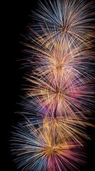 Vibrant fireworks explode in a dazzling display against the dark night sky