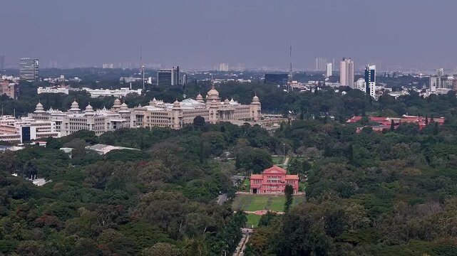 Aerial view of Vidhana Soudha government building surrounded by lush trees in Bengaluru
