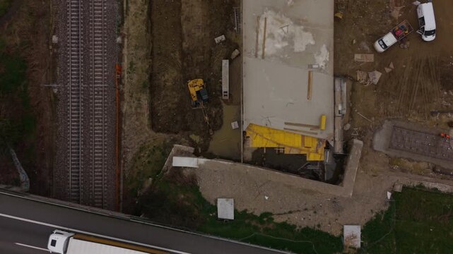 Railway tunnel construction under Milan, Italy, showing heavy machinery, excavation equipment, and new high speed train infrastructure development.