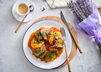 Delicious meal with meat and vegetables served with coffee on a table decorated with lavender...