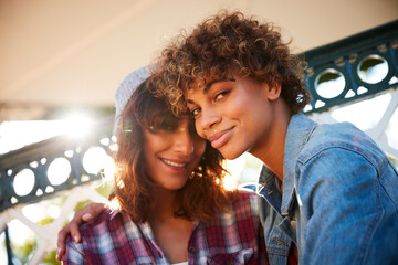 Portrait, love and smile with lesbian couple in park for commitment, bonding and summer holiday. Happy, lgbt connection and date with women in nature for romantic vacation, support and care together