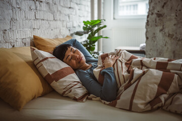 Woman resting peacefully in bed during comfortable morning nap