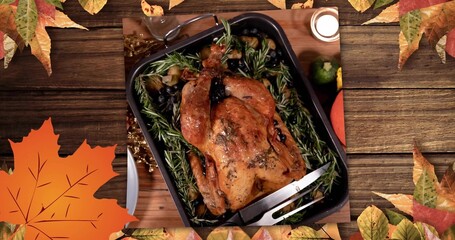 Presenting roasted whole bird resting in black roasting pan on wooden plank, with rosemary