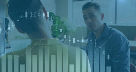 Discussing male consultant in blue shirt speaking at office, with monitor and candlestick charts © vectorfusionart