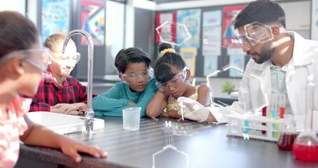 Fototapeta premium Guiding instructor in lab coat and goggles demonstrating pipette in school lab, with test tubes