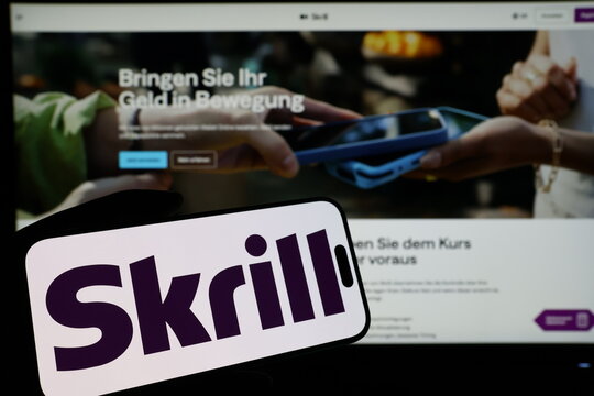 Kiel, Germany - 03-06-2026: Smartphone displaying UK digital payments company Skrill logo in front of companys webpage