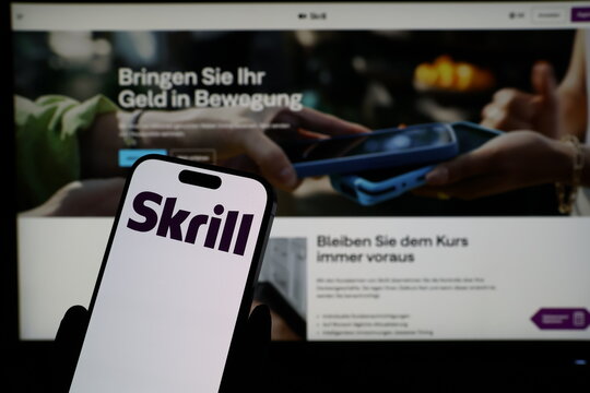 Kiel, Germany - 03-06-2026: Smartphone displaying UK digital payments company Skrill logo in front of companys webpage