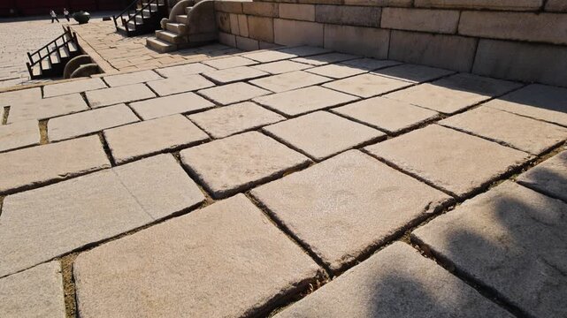 Ancient palace courtyard showcasing weathered Gyeongbokgung modern skyline