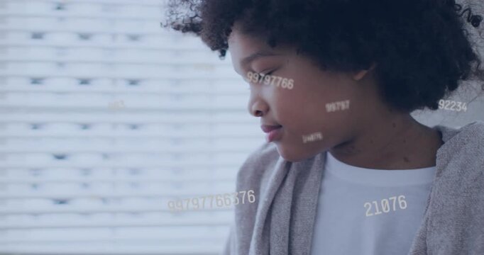 Boy turning left while numeric overlay appearing, drifting across face and blinds, studying tech