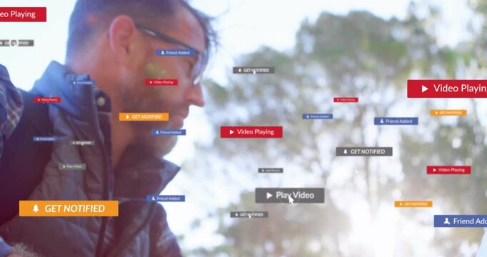Vertical video: Man tapping phone in park causing play or notify icons spreading checking IT alerts