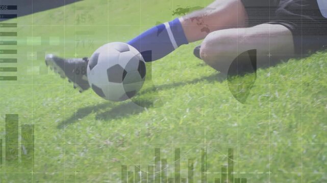 Male player sliding on grass field after rolling soccer ball, using soccer cleats and intercepting