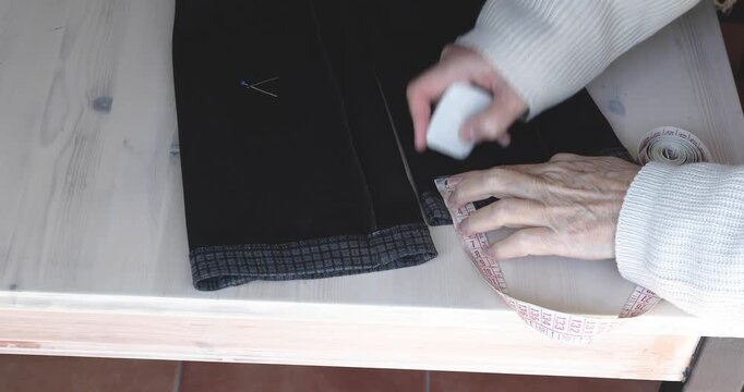 Marking Trouser Hem with Tailor Chalk After Measuring Length
